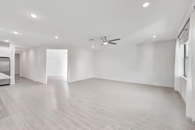 unfurnished room featuring light hardwood / wood-style floors and ceiling fan