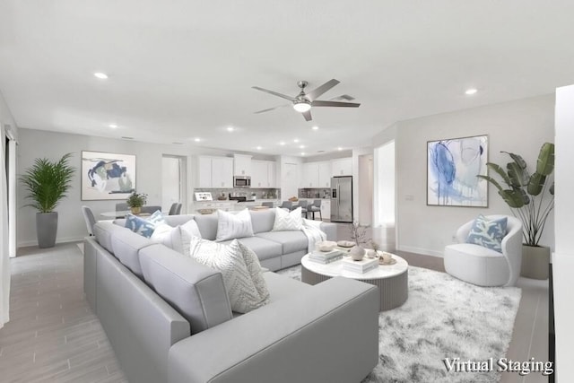 living room with ceiling fan and light hardwood / wood-style floors