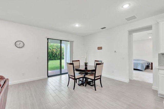 dining space with light hardwood / wood-style floors