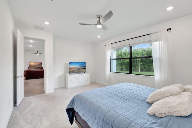 bedroom with ceiling fan and light colored carpet