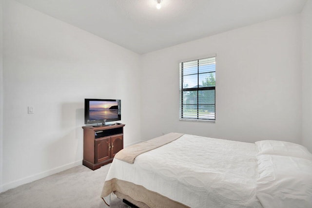 bedroom with light colored carpet