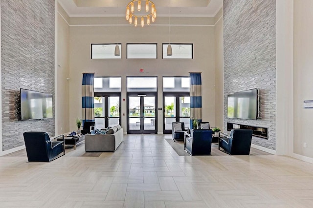 dining space featuring ornamental molding, light tile patterned floors, a notable chandelier, and a high ceiling