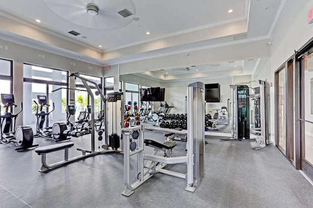 exercise room featuring ceiling fan, ornamental molding, french doors, and a tray ceiling