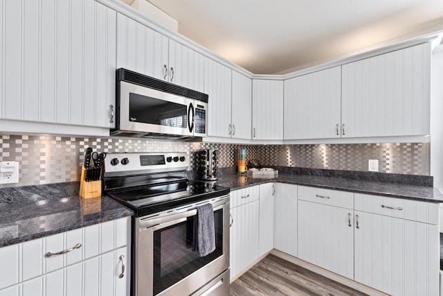 kitchen featuring tasteful backsplash, white cabinetry, appliances with stainless steel finishes, and light wood-type flooring