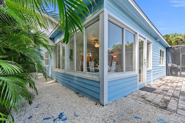 view of side of property featuring a sunroom