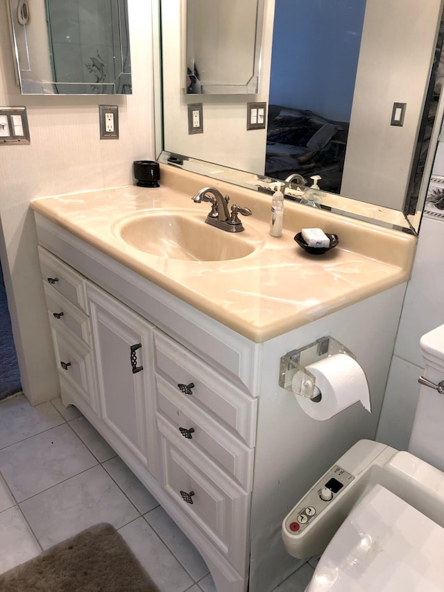 bathroom featuring toilet, vanity, and tile patterned floors