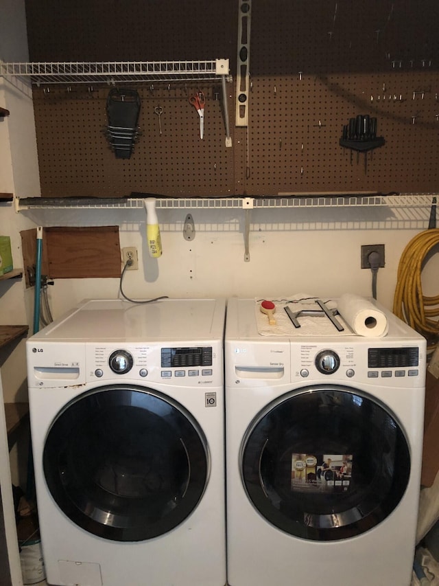 clothes washing area with laundry area and washer and dryer