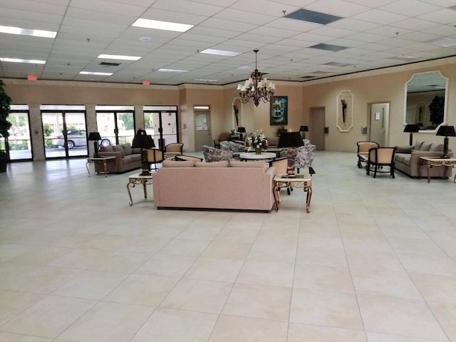 living room with an inviting chandelier, light tile patterned floors, visible vents, and a drop ceiling