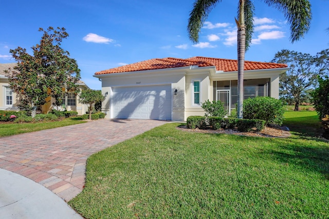 mediterranean / spanish-style home with a front yard and a garage