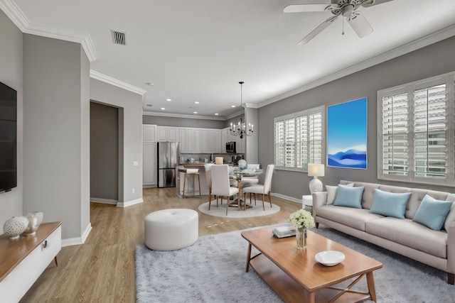 living room featuring a wealth of natural light, light hardwood / wood-style floors, and ornamental molding