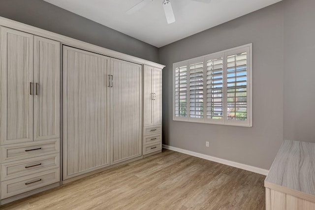 unfurnished bedroom with ceiling fan and light hardwood / wood-style flooring