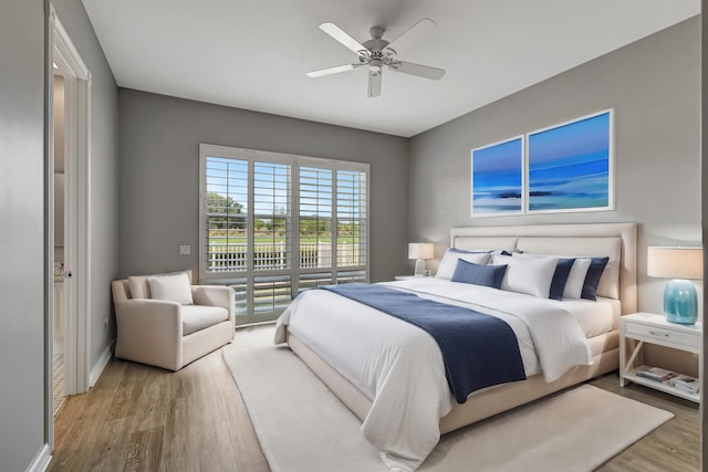 bedroom with hardwood / wood-style floors and ceiling fan