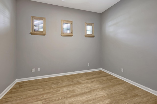 spare room with light wood-type flooring and a healthy amount of sunlight