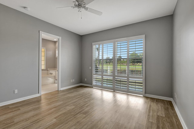 unfurnished room featuring ceiling fan and light hardwood / wood-style flooring