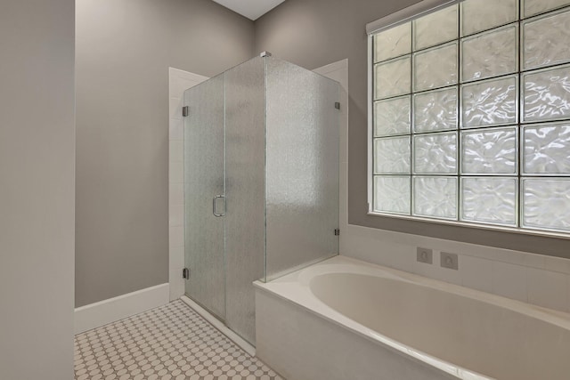 bathroom featuring independent shower and bath and tile patterned flooring