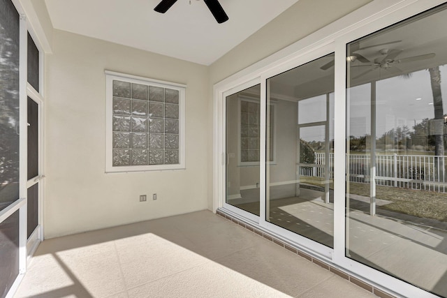 unfurnished sunroom with ceiling fan