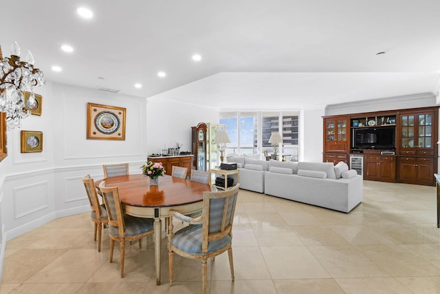 dining room featuring light tile patterned floors, beverage cooler, and crown molding