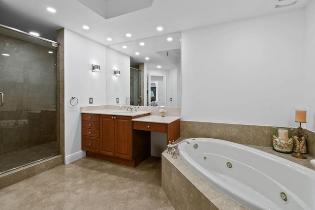 bathroom featuring vanity and independent shower and bath