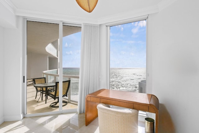 office space with floor to ceiling windows, crown molding, a water view, and a beach view