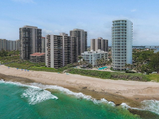 bird's eye view featuring a water view and a beach view