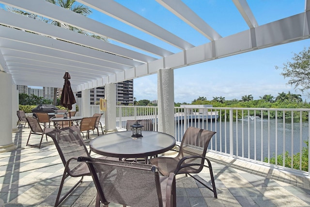 view of patio with a pergola, a water view, and a balcony