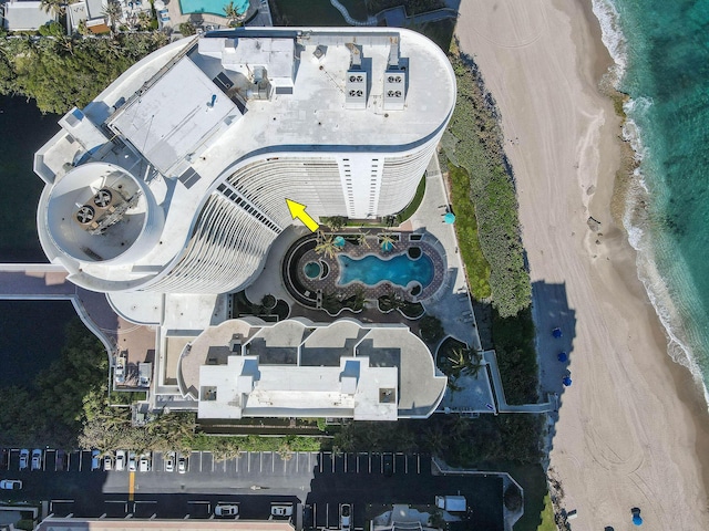 birds eye view of property with a water view and a view of the beach