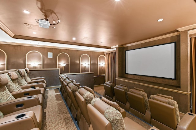 carpeted home theater room with ornamental molding