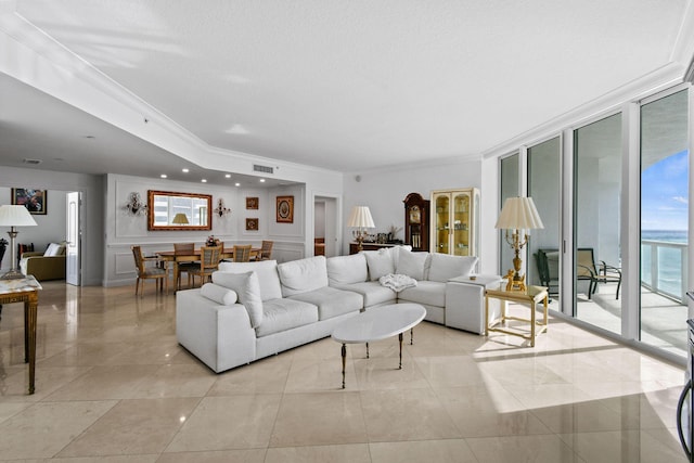 living room featuring crown molding, expansive windows, and a textured ceiling