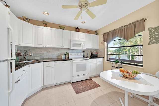 kitchen with white cabinetry, sink, ceiling fan, white appliances, and light tile patterned flooring