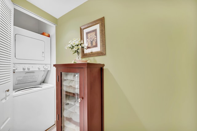 washroom featuring stacked washer and clothes dryer