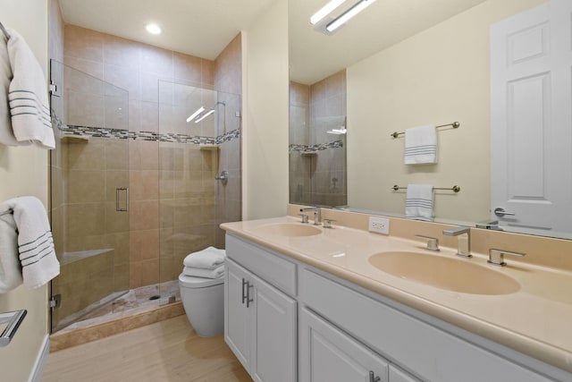 bathroom featuring vanity, an enclosed shower, and toilet