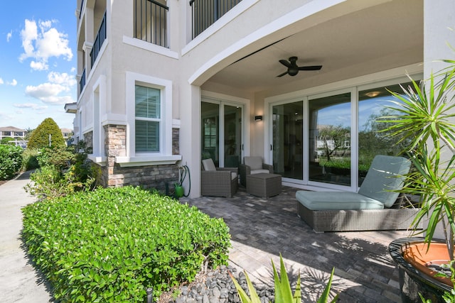 doorway to property with a patio and ceiling fan