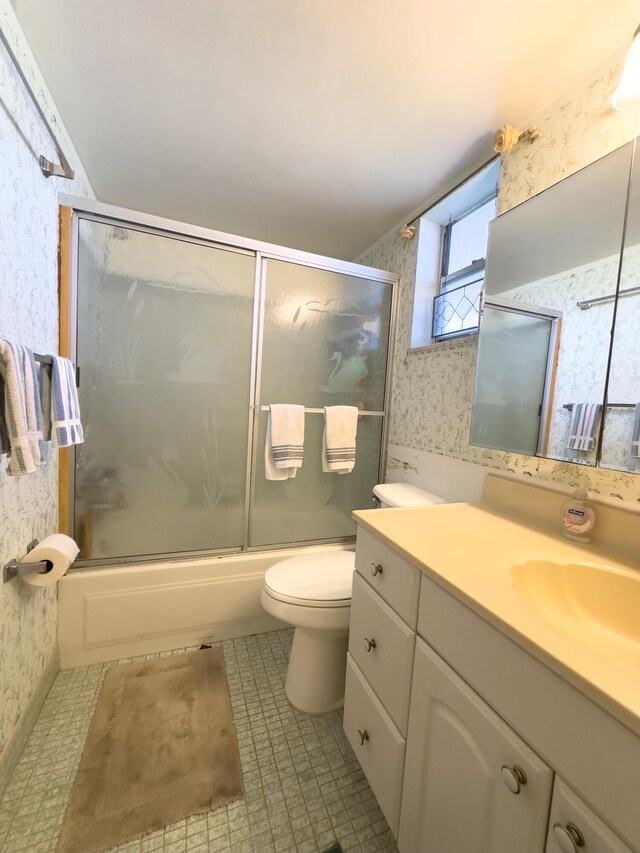 full bathroom with vanity, toilet, tile patterned floors, and combined bath / shower with glass door