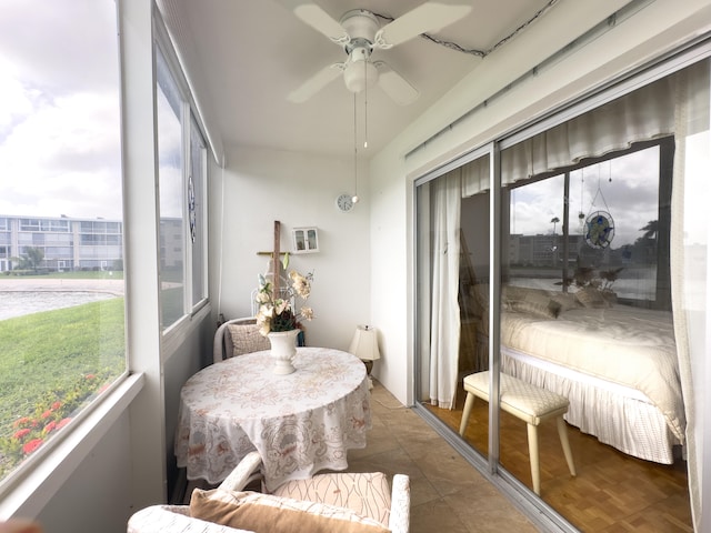 sunroom featuring ceiling fan