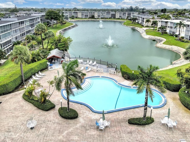 view of pool with a patio and a water view