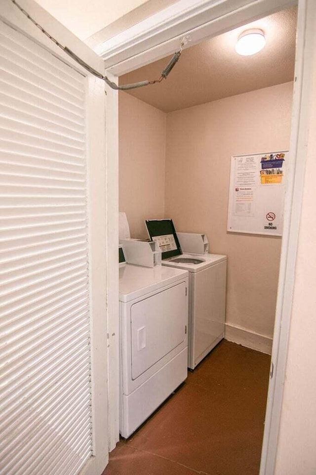 clothes washing area with washing machine and dryer