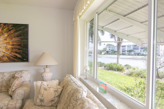 bedroom with multiple windows, a water view, and vaulted ceiling