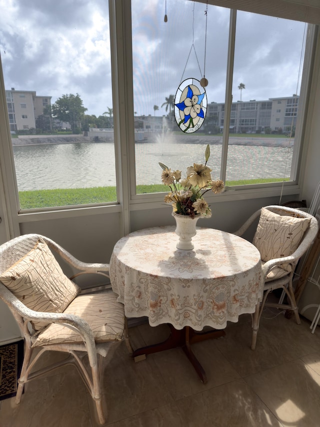 sunroom with a water view and a wealth of natural light