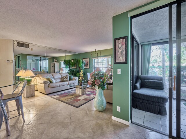 tiled living room with plenty of natural light and a textured ceiling