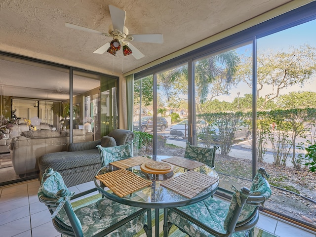 sunroom / solarium featuring ceiling fan