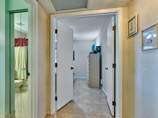 corridor with a textured ceiling