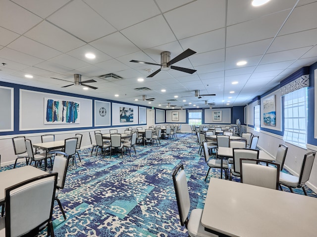 carpeted dining area featuring ceiling fan