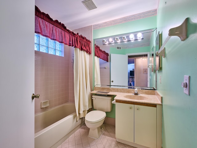 full bathroom featuring tile patterned flooring, vanity, toilet, and shower / bath combination with curtain