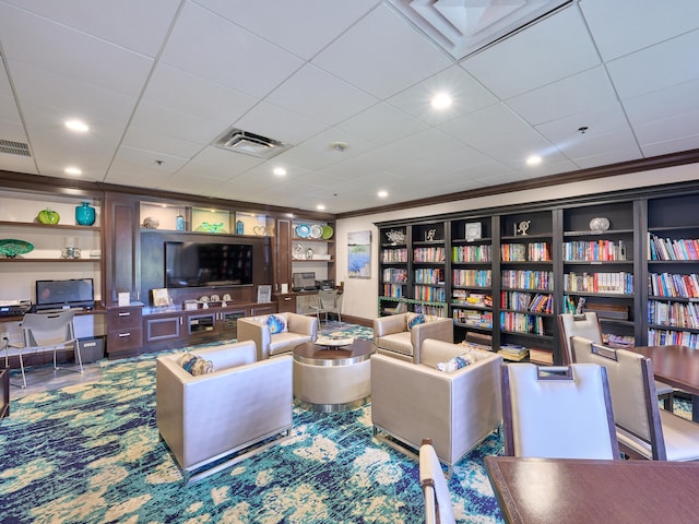 living room with built in features and crown molding