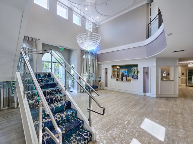 stairs featuring a towering ceiling and an inviting chandelier