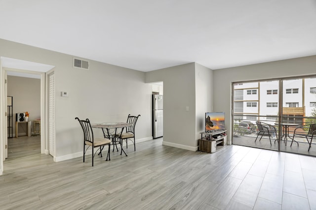 dining area with light hardwood / wood-style floors