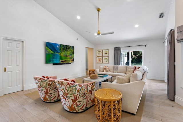 living room featuring high vaulted ceiling and light hardwood / wood-style floors