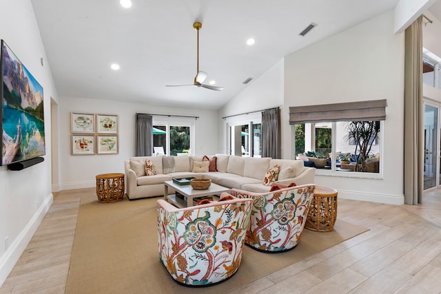 living room featuring lofted ceiling, light wood-type flooring, and ceiling fan