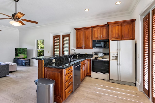 kitchen featuring kitchen peninsula, black appliances, sink, and dark stone counters