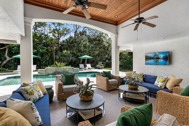 view of patio / terrace with outdoor lounge area, pool water feature, and ceiling fan